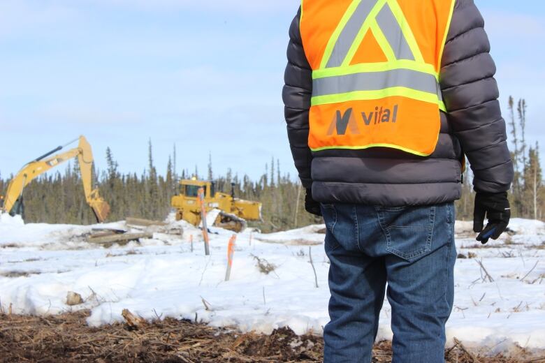 A man wearing a safety vest with the word 