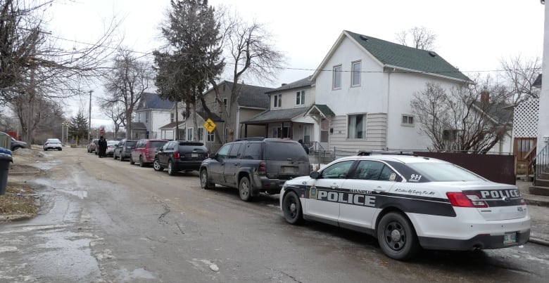 A police car on a residential street.