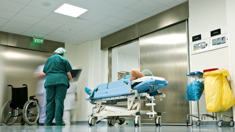 A gurney in front of an elevator in a hospital.