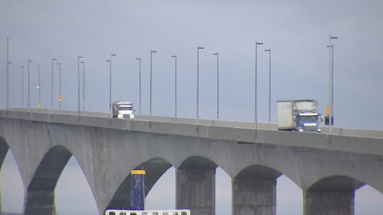 2 trucks driving on Confederation Bridge.