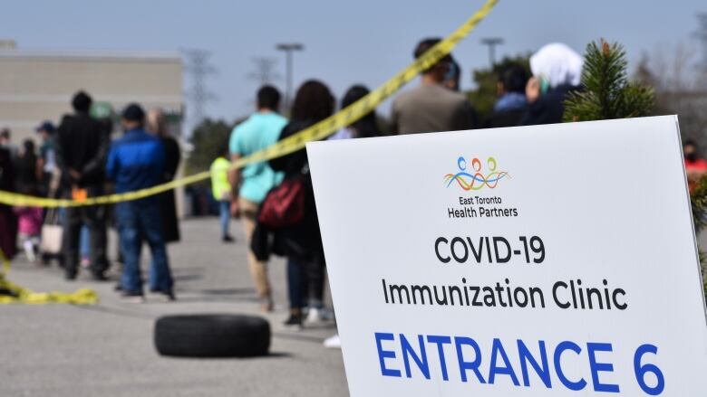 People are lined up to receive a vaccine.