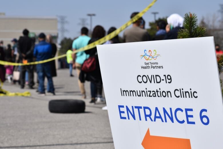 People are lined up to receive a vaccine.