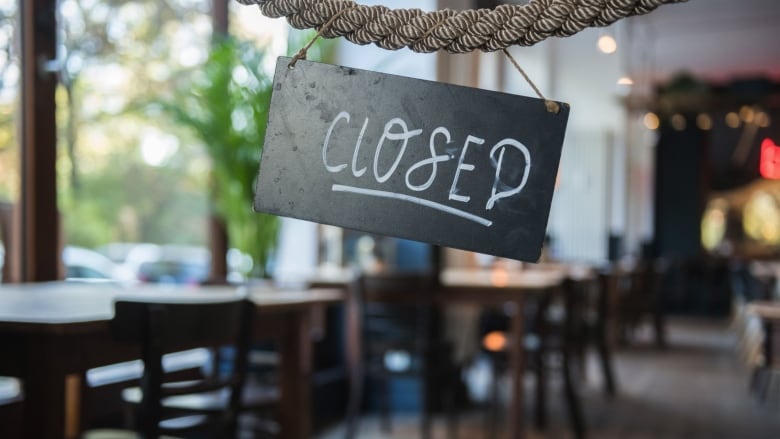 A closed sign hangs in a restaurant.