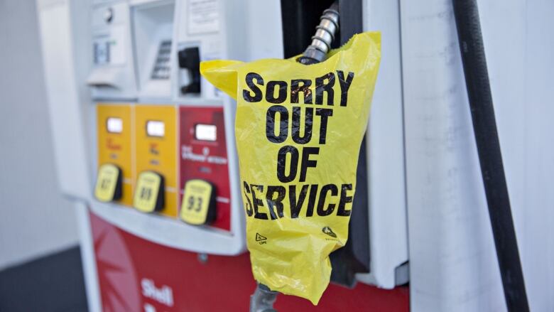 An out of service bag covers a gas pump.