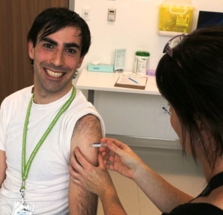 Dr. Matthew Tenenbaum, pictured here receiving a flu shot, is the associate medical officer of health with Wellington-Dufferin-Guelph Public Health.