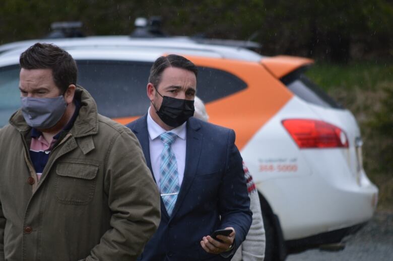 a man looks worried walking to court