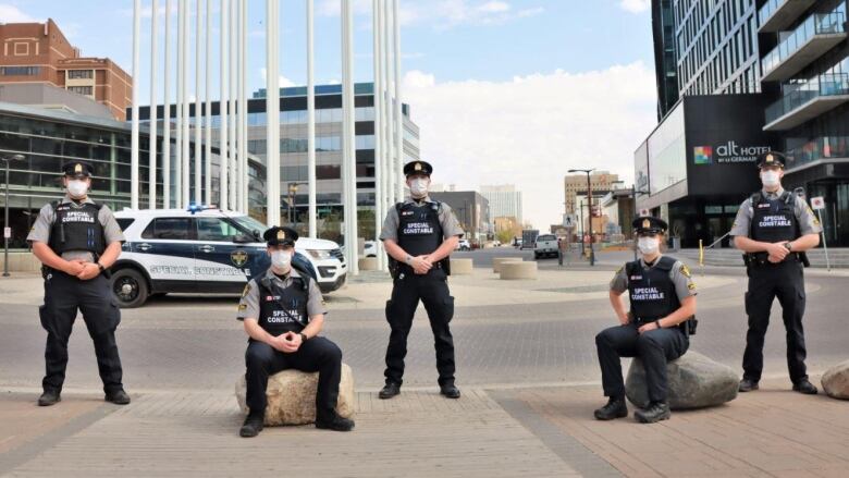 Multiple alternative response officers pose for a photo in downtown saskatoon