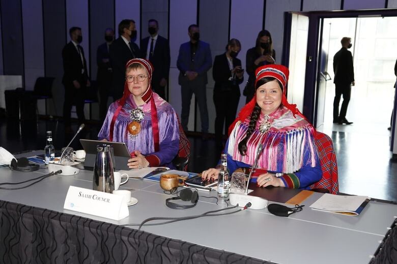 Two members of the Saami Indigenous community are seen at a desk.