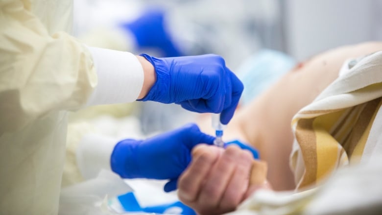 Nurses in a hospital room.