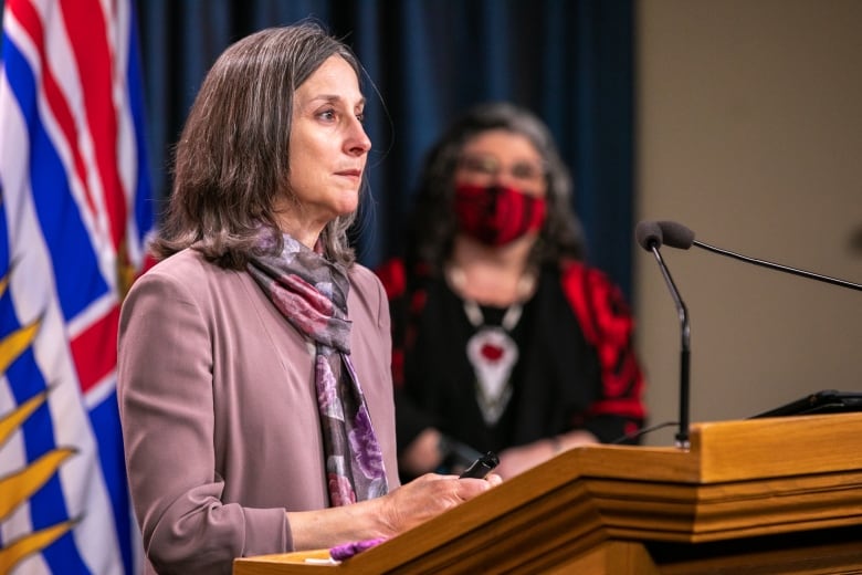 A woman speaks at a podium.