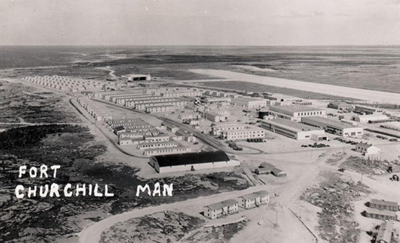 A black and white aerial photo shows buildings and is labelled 