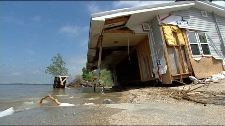 A badly damaged home along a beach.