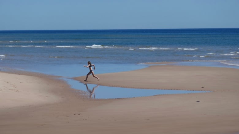 Girl running on beach.