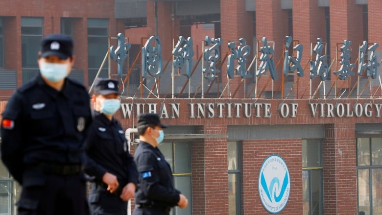 Security personnel keep watch outside Wuhan Institute of Virology in Wuhan, Hubei province, Feb. 3, 2021.