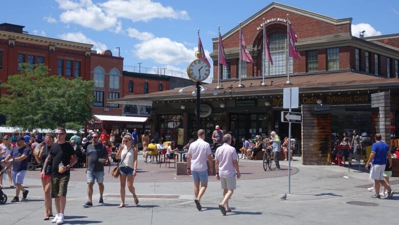 People walk in front of Ottawa's ByWard Market on July 4, 2021. 