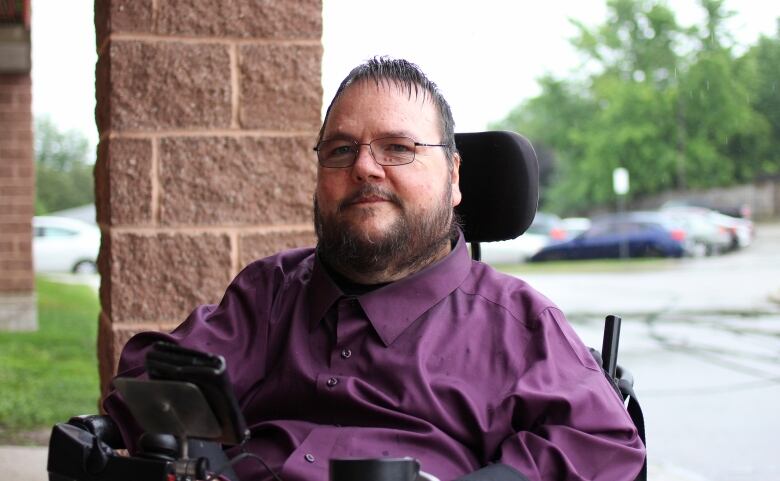 A portrait of a man in a wheelchair.