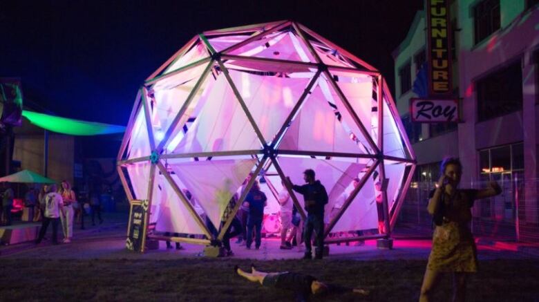 A geodesic dome at night.