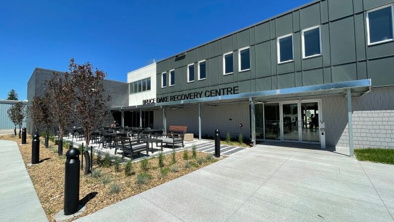 The front of a large building with a small courtyard in the front.