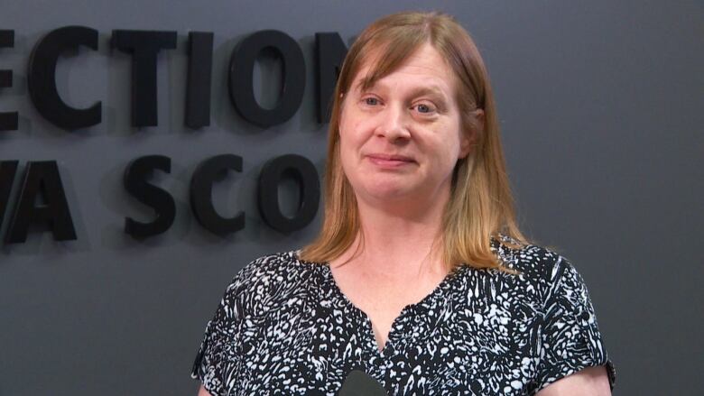 a woman wearing a  patterned blouse 