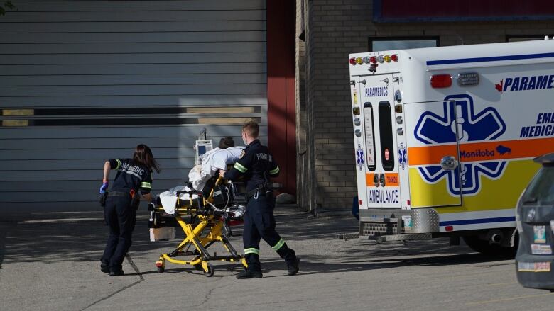 Paramedics, moving a patient outside St. Boniface Hospital in Winnipeg.