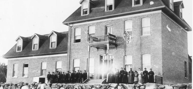 A black and white photo of a residential school building. 