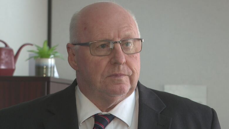 Man in glasses and business suit. 