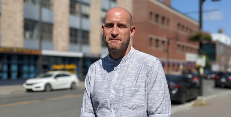 A man standing on a downtown street.