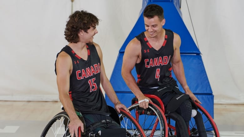 Garrett Ostepchuk (left) and Nik Goncin (right) playing wheelchair basketball.