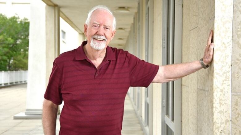 An older man poses for a photo.