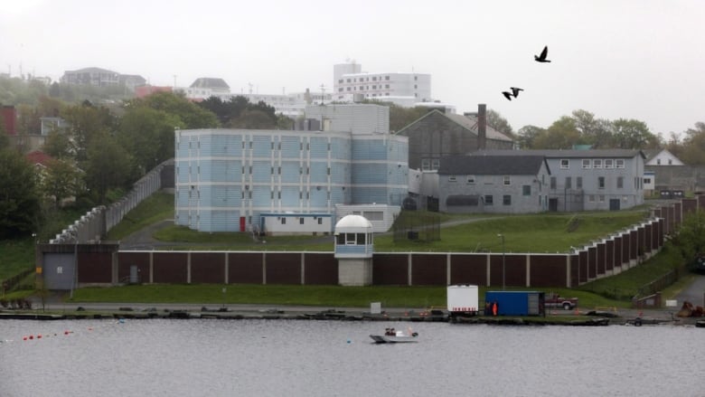 A prison complex on a grassy hill 