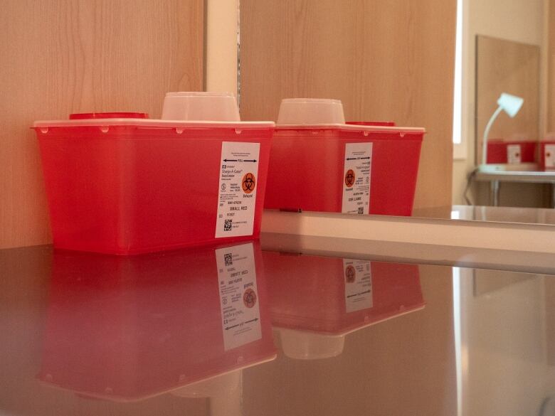 A small red plastic bin sits on a table.