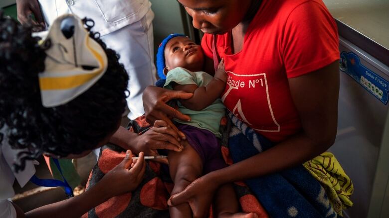 A young child in the Malawi village of Migowi takes a vaccine against malaria, the world's first of its kind.