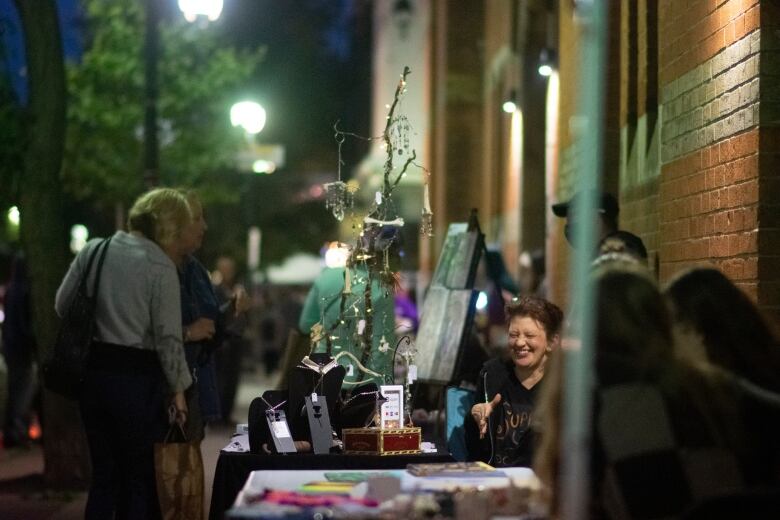 People looking at vendor's art