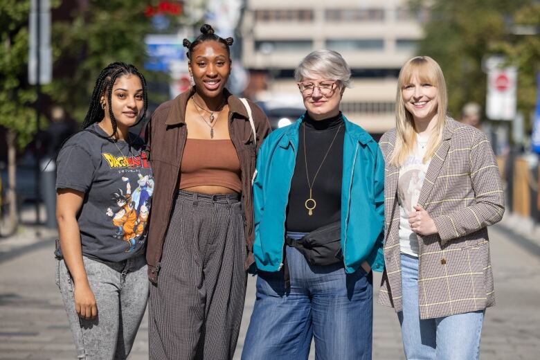 Four women standing on a street