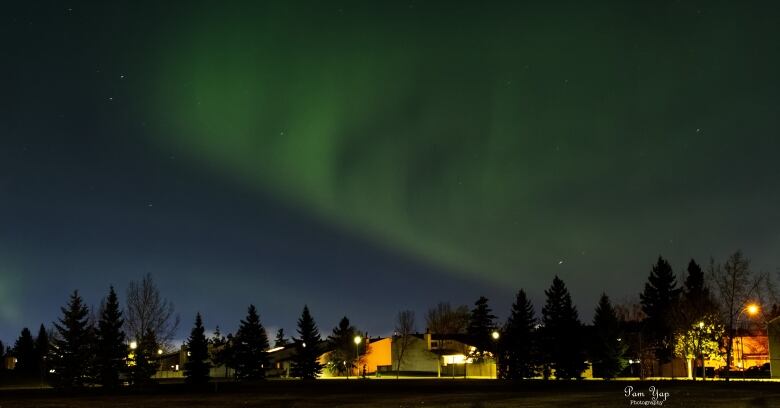 Aurora Borealis flicker behind an Edmonton home. 