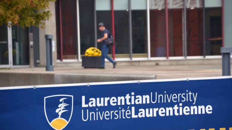 Student with helmet walking into Laurentian University