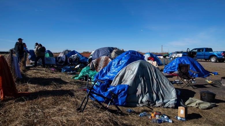 Tents in a prairie field.