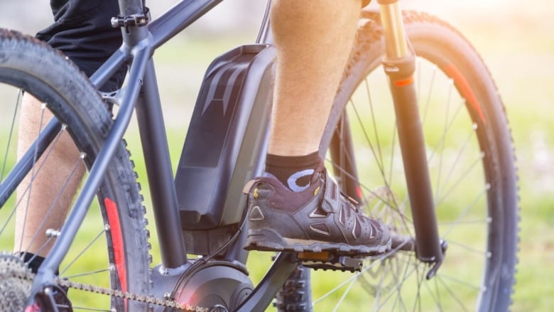 A close up of an E-bike shows the motor fastened to the bike's frame that is used to assist riders when pedalling.