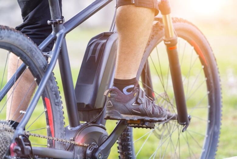 A close up of an E-bike shows the motor fastened to the bike's frame that is used to assist riders when pedalling.