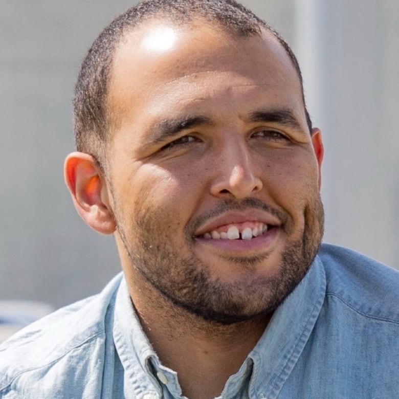 A portrait of a man smiling.