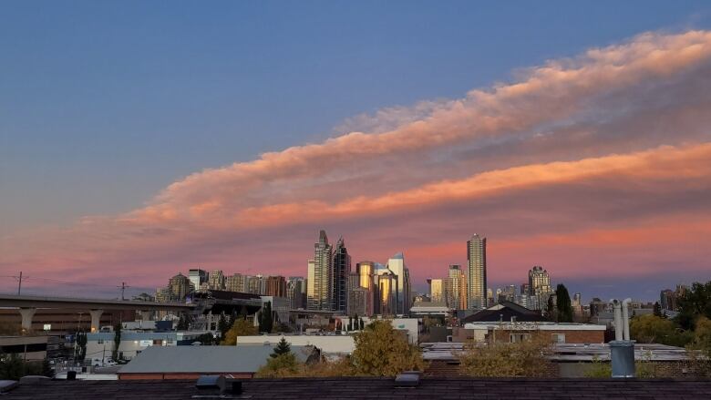 Calgary's skyline glows pink at sunset in fall 2021