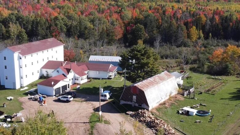 Aerial shot of farm with white buildings