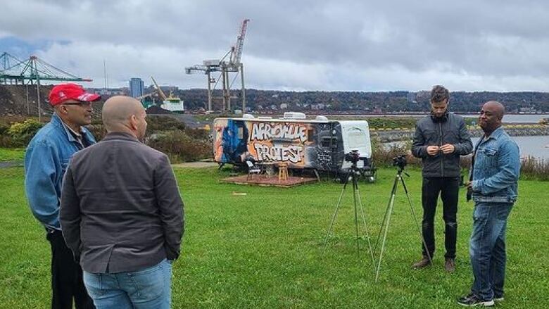 People standing in front of a trailer that reads 