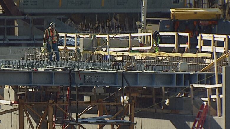 a bridge is pictured with a man in construction gear