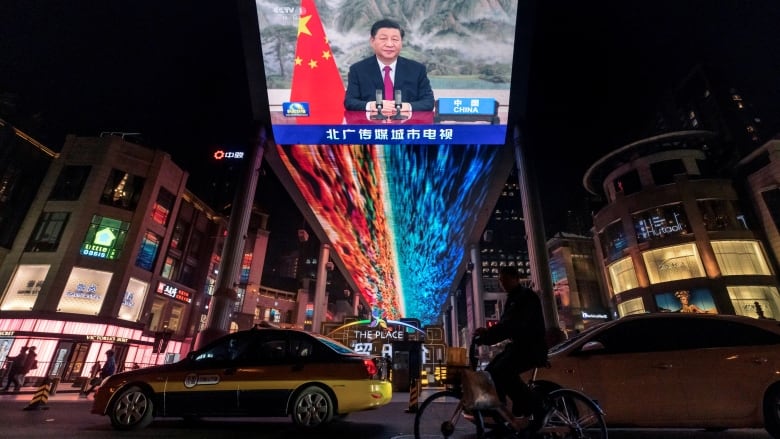 FILE PHOTO: A screen displays a CCTV state media news broadcast showing Chinese President Xi Jinping addressing world leaders at the G20 meeting in Rome via video link at a shopping mall in Beijing, China, October 31, 2021.  