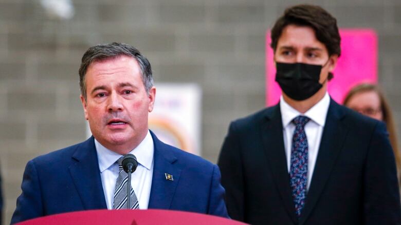 Prime Minister Justin Trudeau, right, looks on as as Alberta Premier Jason Kenney makes a child-care announcement in Edmonton on Nov. 15, 2021.