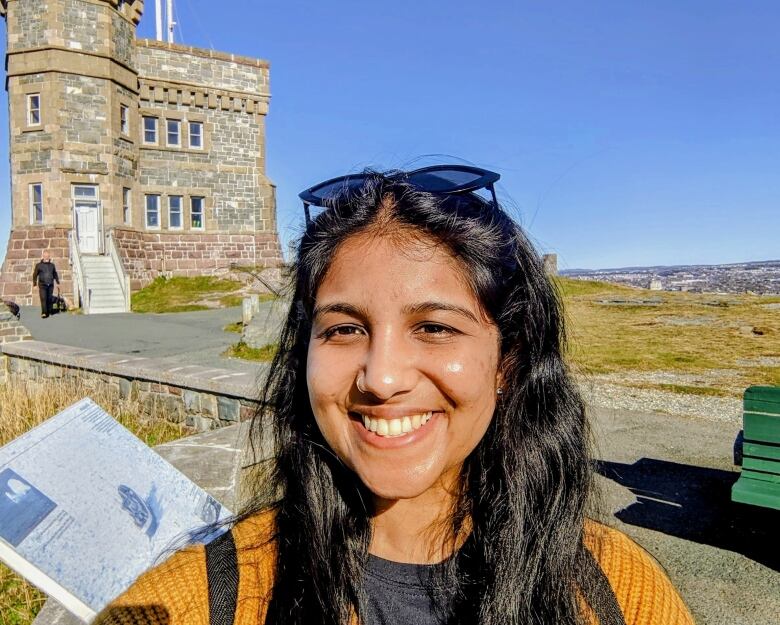 A young woman smiles.