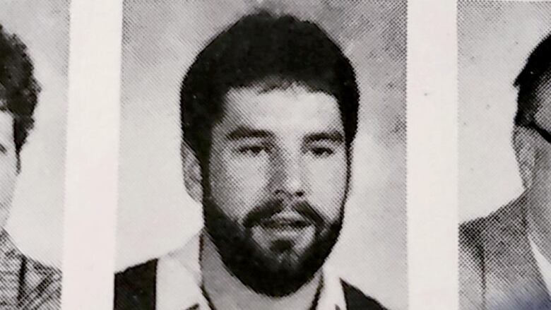 A grainy yearbook photo of a man with a beard. 