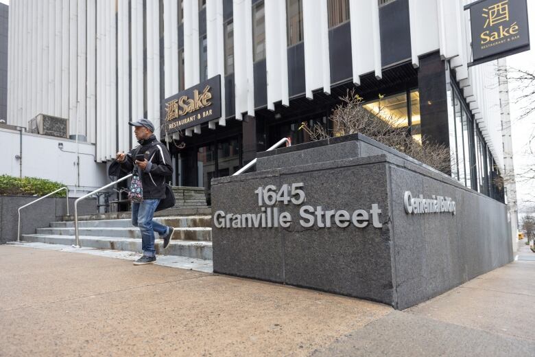 The front entrance of an office building on a street corner.