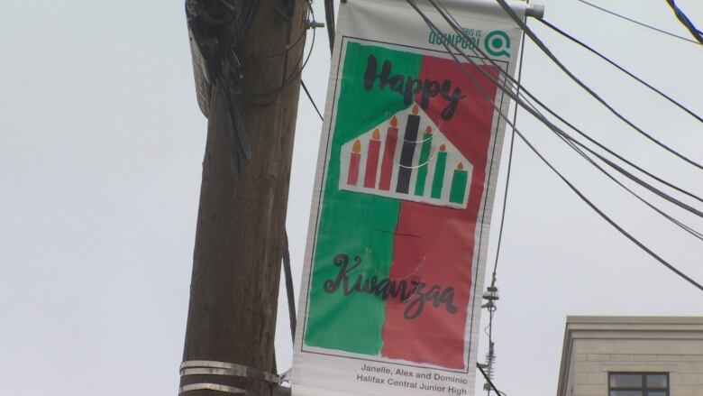 A Happy Kwanza sign on a pole